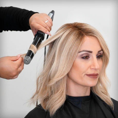 Lady styling a human hair wig