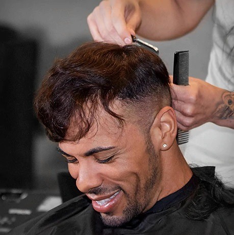 Smilingh man having his bondable hair topper trimmed