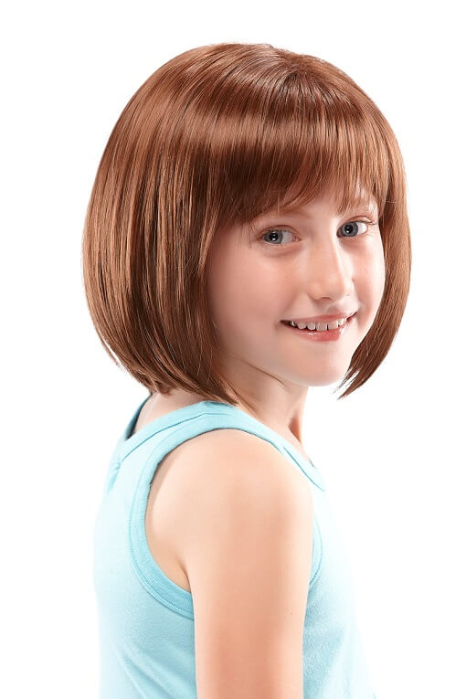 Little girl with complete hair loss wearing the light brown Shiloh Wig