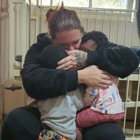A woman hugging and helping  families in need